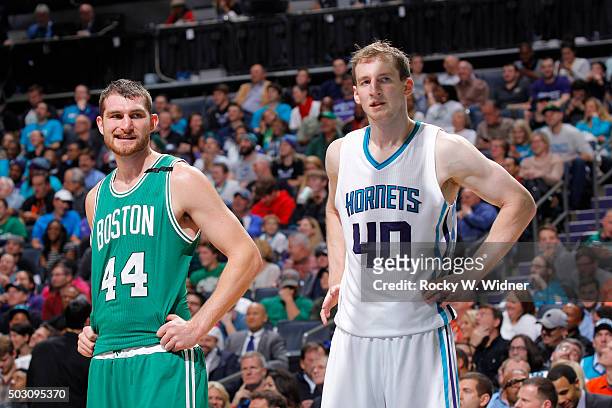 Tyler Zeller of the Boston Celtics faces off against Cody Zeller of the Charlotte Hornets on December 23, 2015 at Time Warner Cable Arena in...
