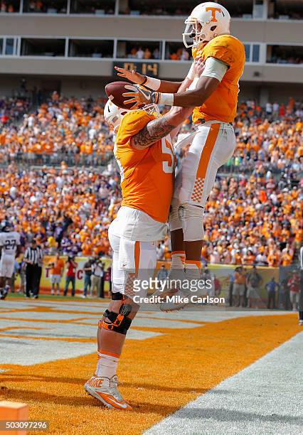 Joshua Dobbs of the Tennessee Volunteers is lifted by Coleman Thomas after scoring a touchdown against the Northwestern Wildcats during the first...