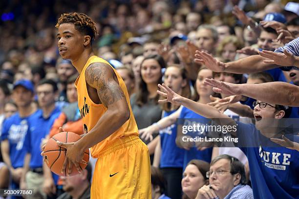 Cameron Crazies and fans of the Duke Blue Devils try to distract Nick Faust of the Long Beach State 49ers at Cameron Indoor Stadium on December 30,...