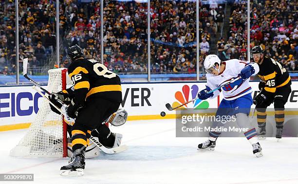 Brendan Gallagher of the Montreal Canadiens bats the puck to score his team's third goal against the Boston Bruins in the second period during the...