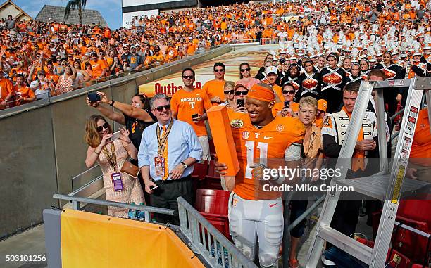 Joshua Dobbs of the Tennessee Volunteers joins the band in the stands to celebrate a win over Northwestern Wildcats in the Outback Bowl at Raymond...