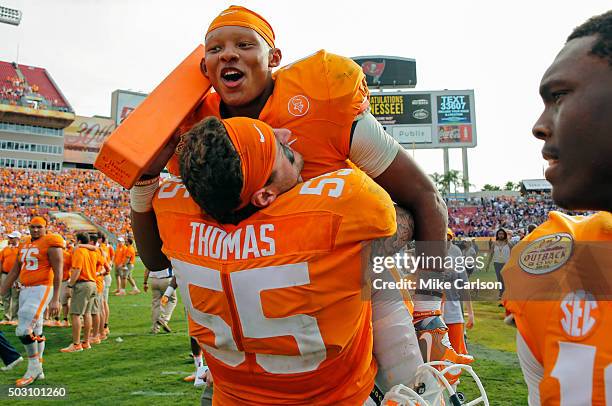 Joshua Dobbs of the Tennessee Volunteers is lifted by Coleman Thomas of the Tennessee Volunteers as they celebrate a win over Northwestern Wildcats...