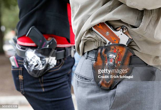 Art and Diana Ramirez of Austin with their pistols in custom-made holsters during and open carry rally at the Texas State Capitol on January 1, 2016...