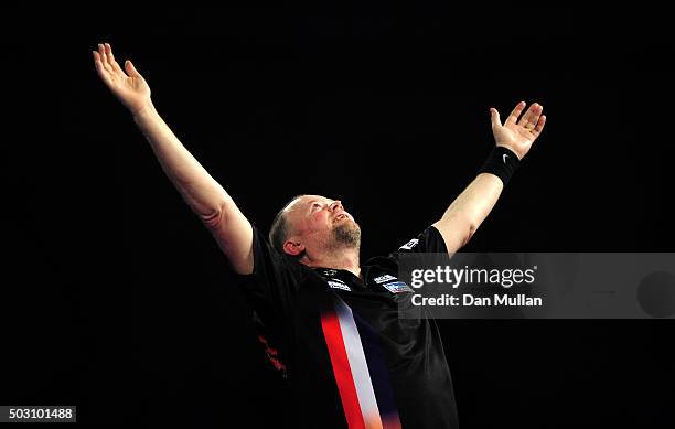 Raymond van Barneveld of the Netherlands celebrates victory over Michael Smith of England in their quarter final match during Day Thirteen of the...