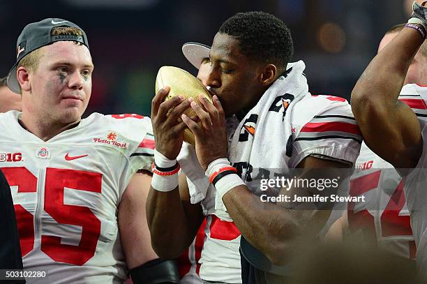 Wide receiver Michael Thomas of the Ohio State Buckeyes kisses the Fiesta Bowl trophy after the BattleFrog Fiesta Bowl at University of Phoenix...