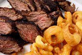 Flank steak with fries onion rings