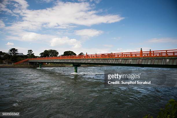 bridge crossing uji river during high tide - uji kyoto stockfoto's en -beelden