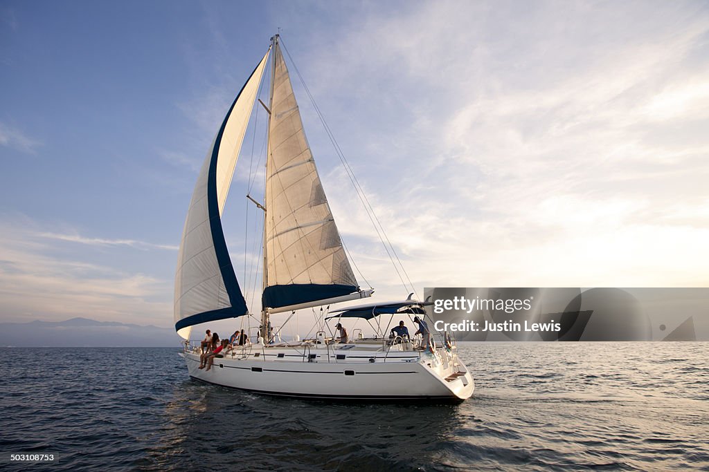 Sunset on the open ocean w/beautiful sailboat