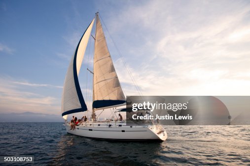 Sunset on the open ocean w/beautiful sailboat