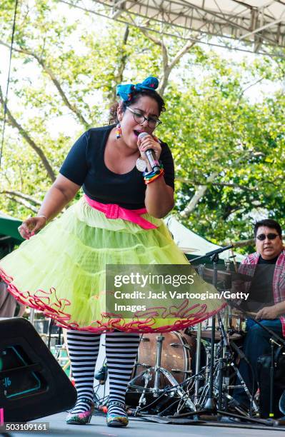 Singer Marisol 'La Marisoul' Hernandez and Ruben Ordiena, on drums, of the band La Santa Cecilia performs at the final concert of the 15th Annual...