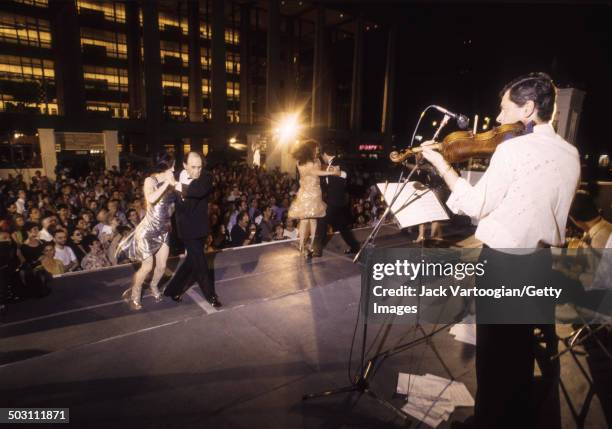 Tango dancers perform to a live band on the Fountain Plaza at Lincoln Center's Midsummer Night Swing, New York, New York, July 9, 1993.