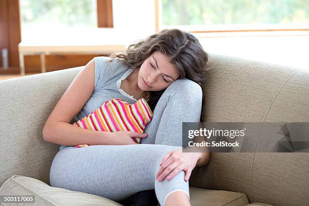 mujer joven con calambres - pm fotografías e imágenes de stock