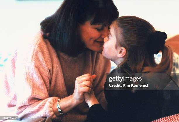 Author Dr. Nancy Snyderman playfully rubbing noses w. Daughter Rachel at home.