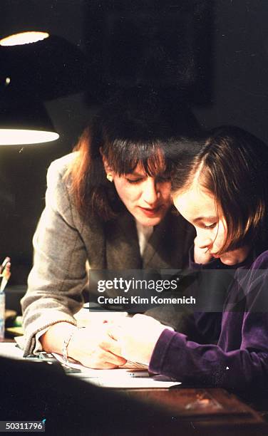 Author Dr. Nancy Snyderman helping daughter Kate w. Homework at home.