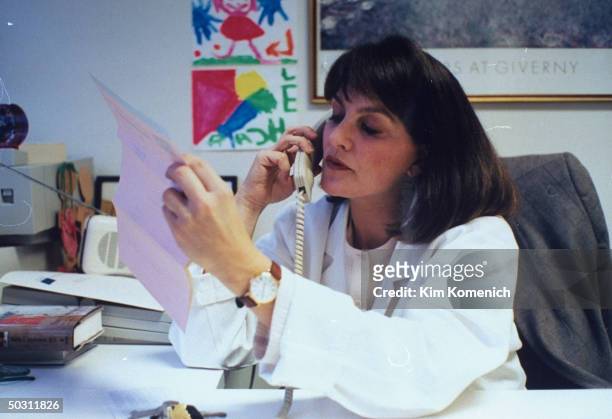 Author Dr. Nancy Snyderman talking on telephone in her office.