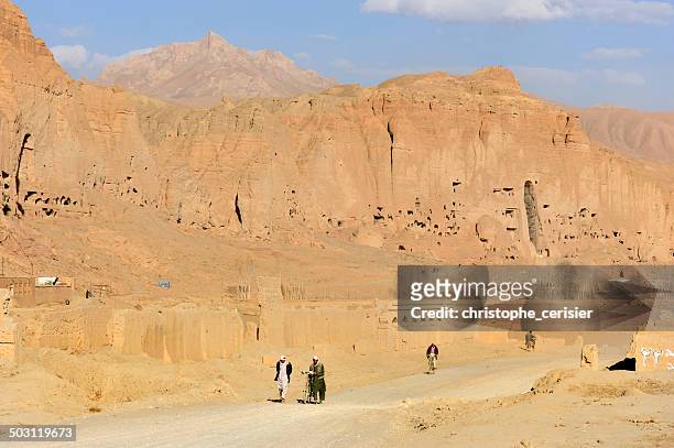 men walking on dirt road, afghanistan - bamiyan buddhas stock pictures, royalty-free photos & images