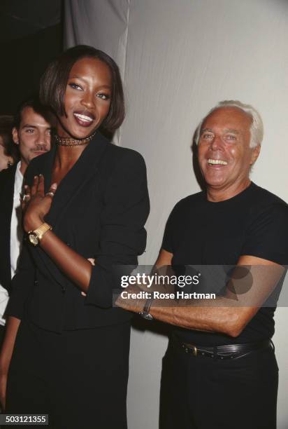 Italian fashion designer Giorgio Armani and English model Naomi Campbell attend a private party, 1996.
