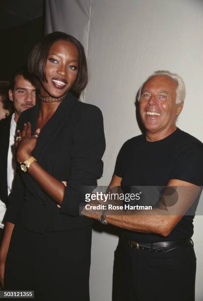 Italian fashion designer Giorgio Armani and English model Naomi Campbell attend a private party, 1996.