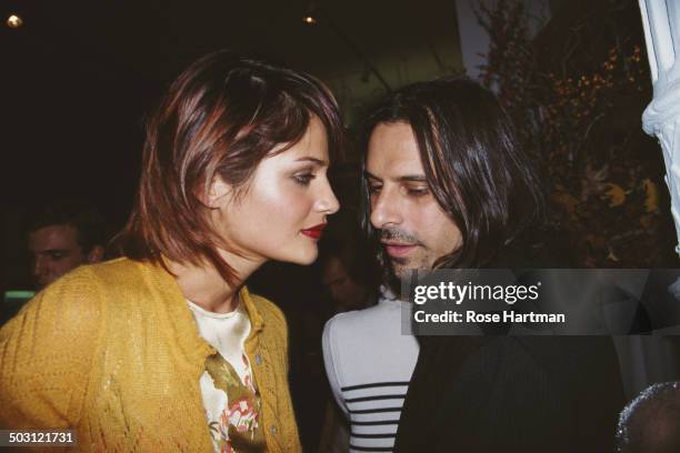 Danish fashion model and photographer Helena Christensen and American photographer Sante D'Orazio attend a Vogue Magazine party, 1995.