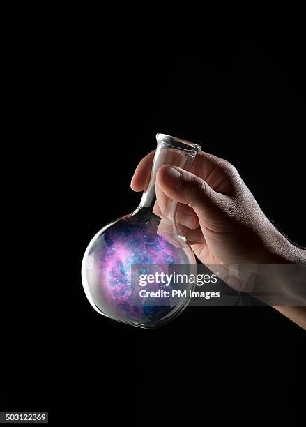 outer space in a flask - glaskolben stock-fotos und bilder