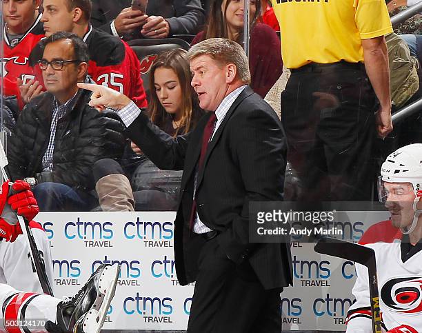 Head coach Bill Peters of the Carolina Hurricanes gives instructions against the New Jersey Devils during the game at the Prudential Center on...