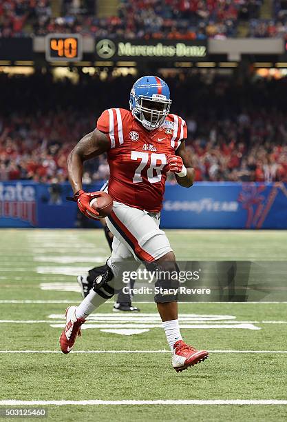Laremy Tunsil of the Mississippi Rebels scores runs in a touchdown during the second quarter against the Oklahoma State Cowboys in the Allstate Sugar...