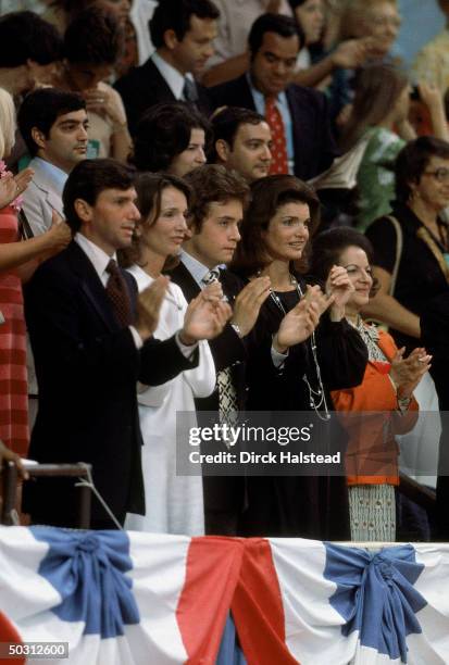 Former First Lady Jackie Kennedy Onassis w. Sister Lee Radziwill and Radziwill's son Anthony applauding at Democratic National Convention.