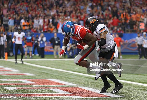 Laquon Treadwell of the Mississippi Rebels scores a touchdown against Jordan Sterns of the Oklahoma State Cowboys during the second quarter of the...