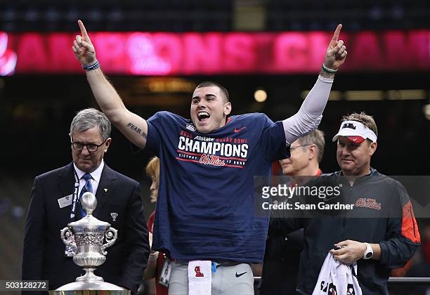 Quarterback Chad Kelly of the Mississippi Rebels celebrates their 48-20 win over the Oklahoma State Cowboys during the trophy presentation after the...
