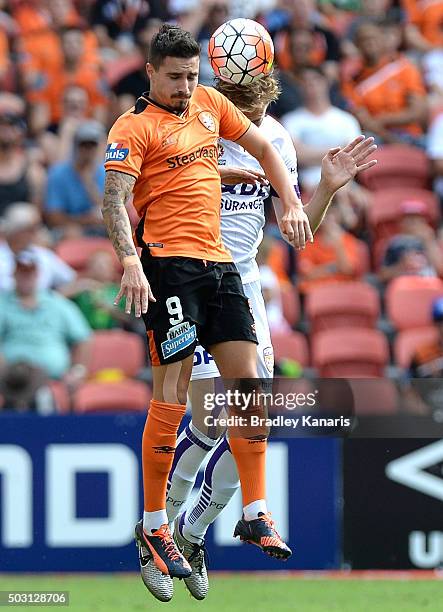 Jamie Maclaren of the Roar and Michael Thwaite of the Glory compete for the ball during the round 13 A-League match between the Brisbane Roar and the...