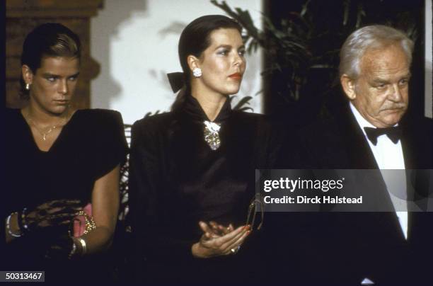 Princess Caroline , Princess Stephanie , and their father Prince Rainer III attending the unveiling of a bust of Princess Grace of Monaco.
