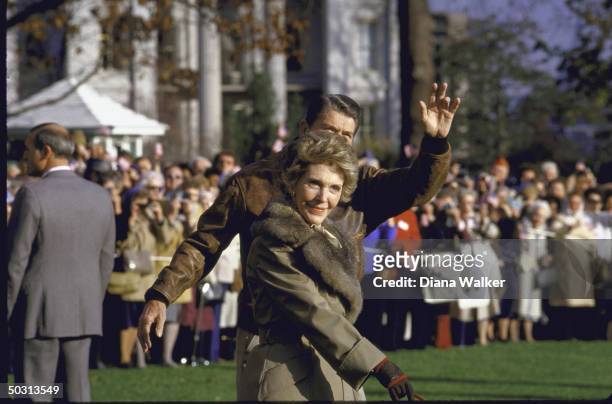 United States President, Ronald W. Reagan, casually clad, with wife Nancy, as they acknowledge fans before boarding Marine One for Camp David.