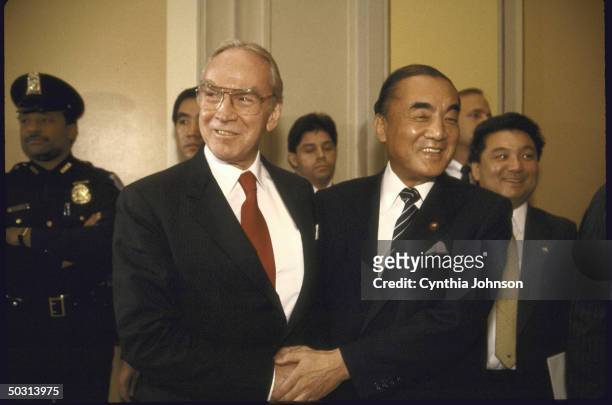 Speaker of the House James C. Wright Jr. Shaking hands with Japan's Prime Minister Yasuhiro Nakasone .