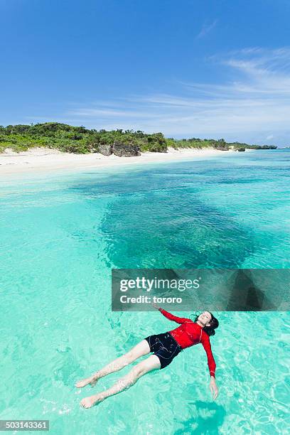 woman enjoying clear tropical water. - aragusuku island stock pictures, royalty-free photos & images