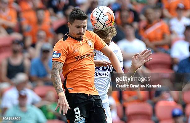 Jamie Maclaren of the Roar and Michael Thwaite of the Glory compete for the ball during the round 13 A-League match between the Brisbane Roar and the...