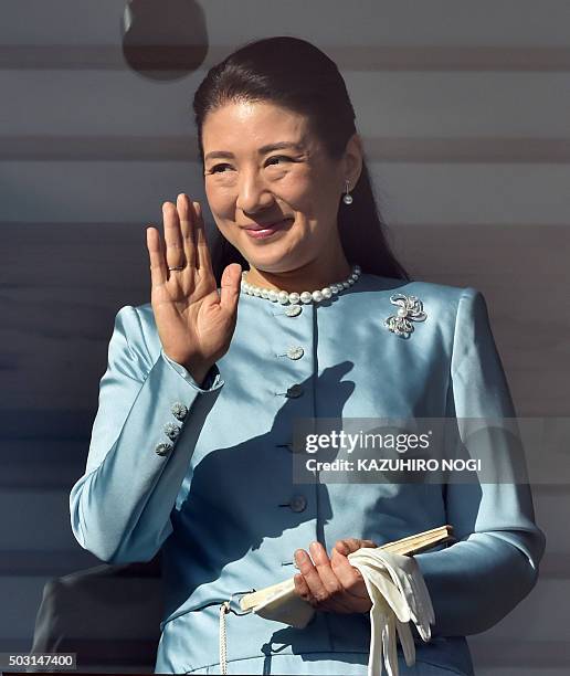 Japanese Crown Princess Masako waves to well-wishers gathered for the annual New Year's greetings at the Imperial Palace in Tokyo on January 2, 2016....