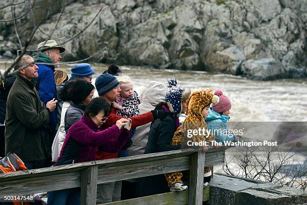 Visitors get a view of the Potomac River's Great Falls at the Chesapeake and Ohio Canal National Historical Park on Friday, January 1 in Potomac, MD....