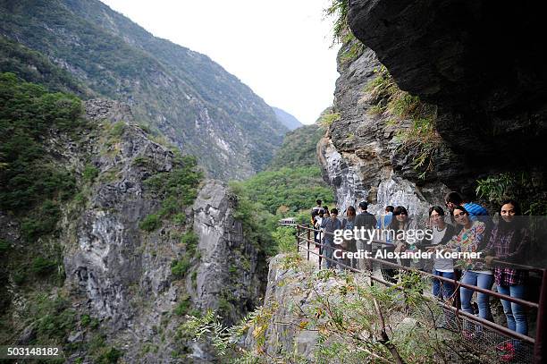 Tourists walk on a trail towards Loushao at a canyon above the Leewo Ho River inside Taroko National Park on January 2, 2016 in Hualien, Taiwan. The...