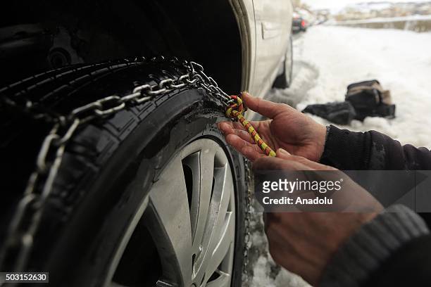 People put chains on the tires of their cars in order to prevent accidents due to snow at Bhamdoun town in Beirut, Lebanon on January 2, 2016.