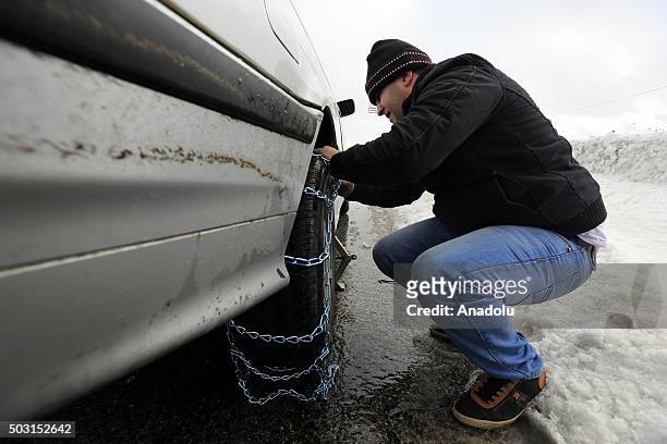 People put chains on the tires of their cars in order to prevent accidents due to snow at Bhamdoun town in Beirut, Lebanon on January 2, 2016.