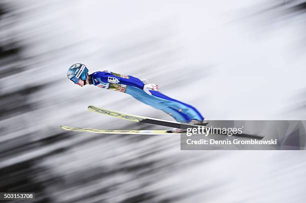 Michael Hayboeck of Austria soars through the air during his qualification jump on day 1 of the 64th Four Hills Tournament ski jumping event on...