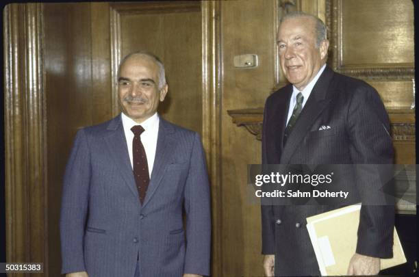 Jordan King Hussein Ibn Talal talking with US State Secretary George P. Schultz.