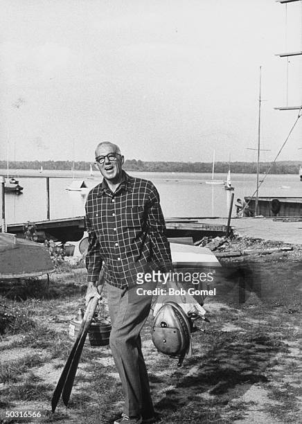 Pediatrician and author Dr. Benjamin M. Spock, cleaning up his boat.