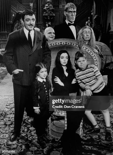 Carolyn Jones and John Astin , with other cast members, during scene from program The Addams Family.