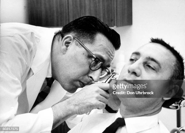Flight surgeon Dr. Charles A. Berry examining astronaut Virgil I. Grissom for sinus trouble.