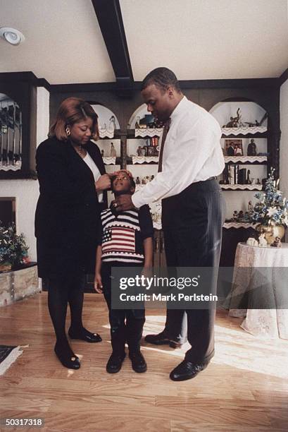 Frankie Watts getting ready for church with youngest son Trey and husband, Rep. J.C. Watts , at home.