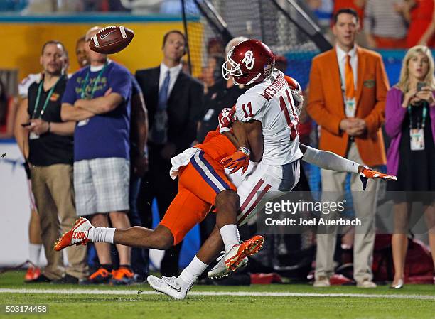 Cordrea Tankersley of the Clemson Tigers breaks up the pass intended for Dede Westbrook of the Oklahoma Sooners during the 2015 Capital One Orange...
