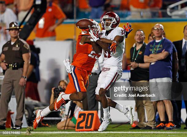 Cordrea Tankersley of the Clemson Tigers breaks up the pass intended for Dede Westbrook of the Oklahoma Sooners during the 2015 Capital One Orange...