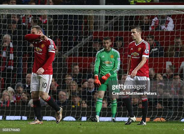 Wayne Rooney, David de Gea and Morgan Schneiderlin of Manchester United show their disappointment at conceding a goal to Gylfi Sigurdsson of Swansea...