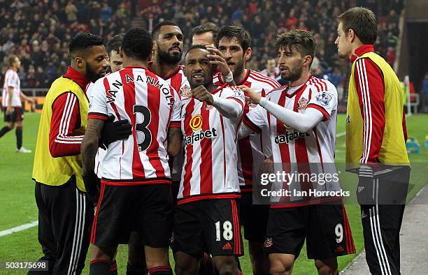 Jermain Defoe of Sunderland celebrates with team-mates after he scores the second Sunderland goal during the Barclays Premier League match between...